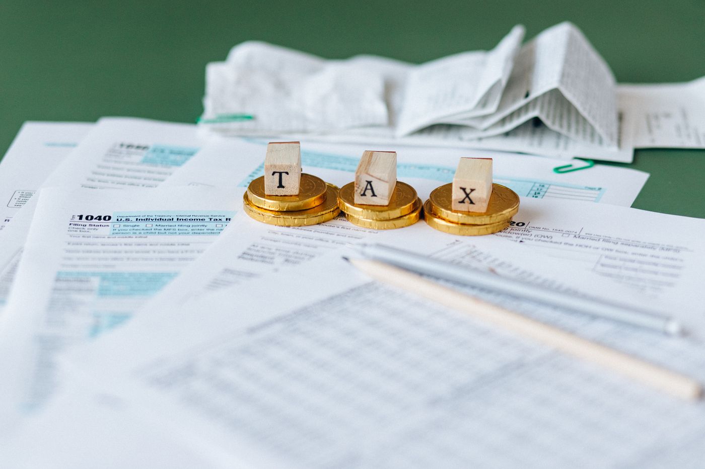 Financial paperwork, coins and a pen on a desk, illustrating compensation administration