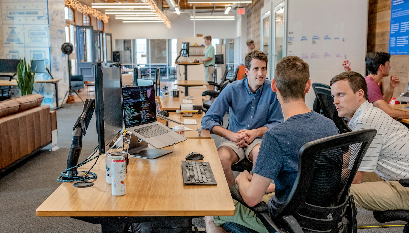Colleagues collaborating around a table on a technology project